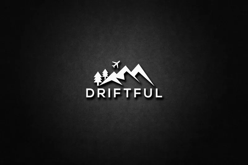 The chosen Driftful mark, mountains, pines and a plane above the word DRIFTFUL, embossed in white on a dark textured wall